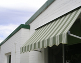 Convertible pivot arm awning