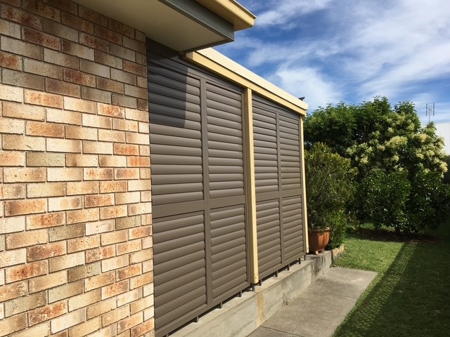 Brown-tone plantation shutters fitted to exterior-facing windows by Apollo Blinds Tamworth.